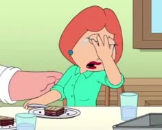 a woman sitting at a table in front of a plate with cake and ice cream on it