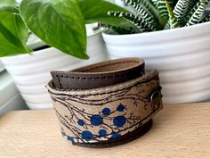 "This item is authentically handmade of genuine leather, it has a hand printed image using indelible (permanent) ink. I've made this wrapping cuff out of soft leather, choose from a black or brown base, and taupe leather. Machine stitched, it has an attached elastic that hooks over a button, so this cuff will adjust to fit most wrist sizes 5.75\" to 7\" in circumference OR select a CUSTOM SIZE in the drop down menu. At the narrowest, the width of the cuff is 1.25\" and at the widest it's 2\". On Leather Jewellery, Bracelet Leather, 30 Gifts, Leather Gifts, Nature Images, Keychain Gift, Leather Wrap Bracelet, Tree Print, Leather Cuffs