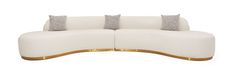 the curved sofa has three pillows on it and is white with gold trimmings