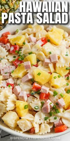 hawaiian pasta salad in a white bowl with pineapples