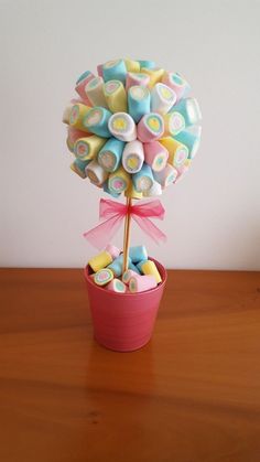 a candy bouquet in a pink pot on a table