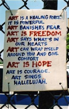 a sign attached to a fence that reads art is a helping force it's powerful banishes fear art is freedom