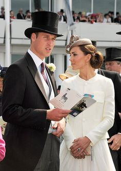 a man and woman standing next to each other in front of a group of people