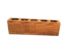 a wooden block with four holes in it