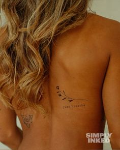 the back of a woman's body with tattoos on her upper and lower half