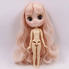 a doll with long blonde hair is posed for the camera on a white background,