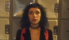 a woman standing in front of some lockers