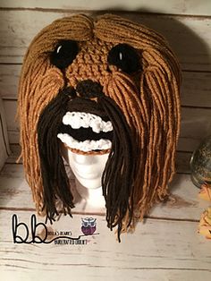 a knitted lion head with dreadlocks on top of a white mannequin's head