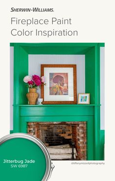 the fireplace is painted green and has flowers on it with a potted plant next to it