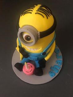 a minion cake with an eyeball on top