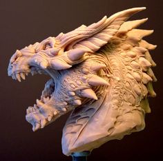 a sculpture of a dragon's head on top of a wooden stand with grey background