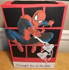 a cardboard box with a spiderman drawing on it