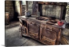 an old fashioned stove with pots and pans on it in a room that is very dirty