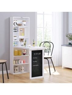 a white bookcase with chalkboard on the front