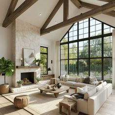 a living room filled with lots of furniture next to a fire place and large windows