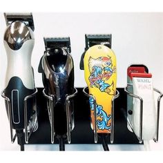 three different types of hair dryers and combs on a black holder with white background