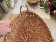 a person is making a basket out of wicker