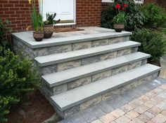 a set of stone steps leading up to a front door