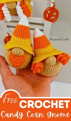 two crocheted candy corn gnomes are shown in front of an orange and white box