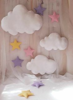 stars and clouds are floating in the air above a bed sheet with sheer drapes