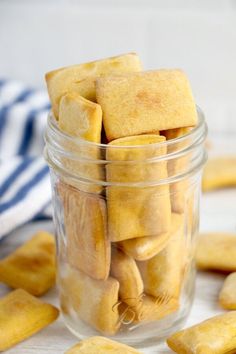 a jar filled with cut up cookies on top of a table