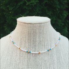 -This necklace is made out of small white, blue, and gold beads  -all necklaces are made with beading string wire and have a clasp in the back White Beaded Chain Choker Jewelry, White Single Strand Choker Necklace, White Beaded Chain Dainty Choker, White Dainty Beaded Chain Choker, White Dainty Beaded Chain Necklace, White Dainty Beaded Necklace, Dainty White Beaded Chain Choker, White Choker Jewelry With Colorful Beads, White Choker With Round Beaded Chain