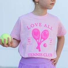 Introducing our pink Tennis Club tee! This print is the perfect addition to our T-shirt, giving it texture and pop. We know you’ll love this tee as much as we’ll do! Glenda The Good Witch, Kids Going To School, Purple Books, Pink Tennis, Rainbow Tutu, Pink Charm, Dress Up Day, Tennis Club, Tennis Clubs