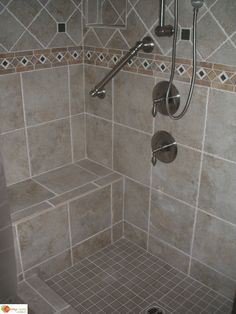 a shower with tiled walls and floor in a bathroom