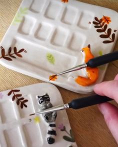 someone is using scissors to cut out the fox figurines on ice trays