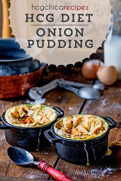 two black pots filled with food sitting on top of a wooden table next to eggs