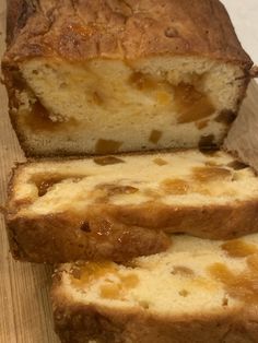 two pieces of bread sitting on top of a wooden cutting board