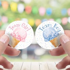 two hands holding up small stickers with ice cream cones on them that say team girl and team boy