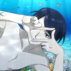 a woman in white swimsuit holding up her hand to her face while standing under the water