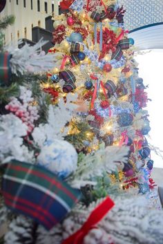 a decorated christmas tree with red, white and blue ornaments