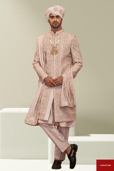 Make a Grand Statement on Your Special Day This Sherwani Design is available in two colours: Rose Gold (1st Pic) & Cream/Beige. Choose as per your liking. Step into luxury with a Handmade Sherwani / Achkan crafted from premium soft blended silk, velvet and cotton blends in a stunning Cream / Gold colour, offering both comfort and sophistication. Our diverse collection features designs to suit every taste: Classic Elegance: Choose a timeless Sherwani with intricate embroidery on the collar or cuf Sherwani Design, Wedding Wear For Men, Cream Sherwani, Ethnic Wedding, Handmade Rose, Gold Work, Wedding Suits Men, Intricate Embroidery, Gold Colour