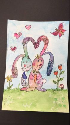 a card with an image of two rabbits in the grass, one holding a carrot