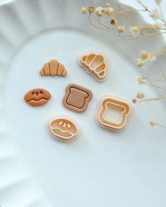 some cookies are sitting on a white plate with flowers in the backgroung