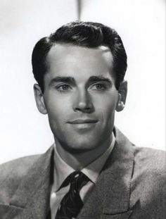 a black and white photo of a man in a suit