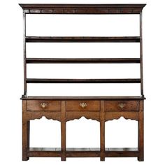 an old wooden shelf with drawers and shelves on the top, against a white background