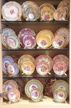 an old china cabinet filled with lots of plates