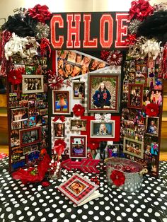 a table topped with pictures and decorations on top of a polka dot covered table cloth