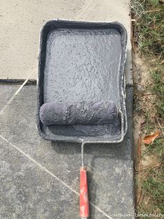 a cement box with a red handle on the ground