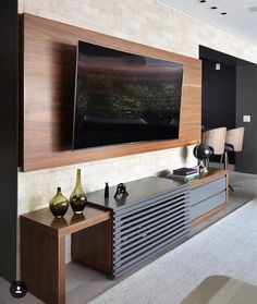 a large flat screen tv mounted to the side of a wall in a living room