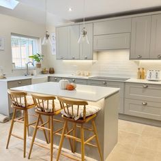 two stools sit at the center of a kitchen island