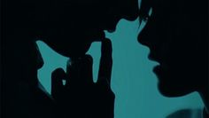 the silhouettes of two people are shown against a blue background and one is holding a cell phone