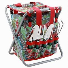 a multicolored cooler with red handles and flowers on the side is holding utensils