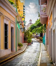 a cobblestone street with colorful buildings on both sides