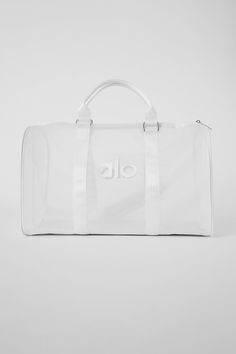 For a weekend trip to the desert or an all-day hang at the beach, this duffle makes your bag the main character. It has an on-trend, see-through design plus a slew of functional features, like a flat bottom (so it stands without slouching or sagging), a top zipper, comfortable top handles and a detachable shoulder strap. Luxury Gym Bag, Clear Mesh Travel Bag, Nylon Weekend Travel Bag, Casual White Duffle Bag With Luggage Sleeve, White Nylon Casual Travel Bag, Nylon Travel Bag With Clear Strap, Travel Nylon Bag With Clear Strap, White Weekender Bag With Luggage Sleeve, White Duffle Bag With Large Capacity For Weekends