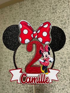 a minnie mouse birthday cake topper with the number two on it