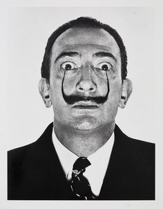 a black and white photo of a man with a fake mustache